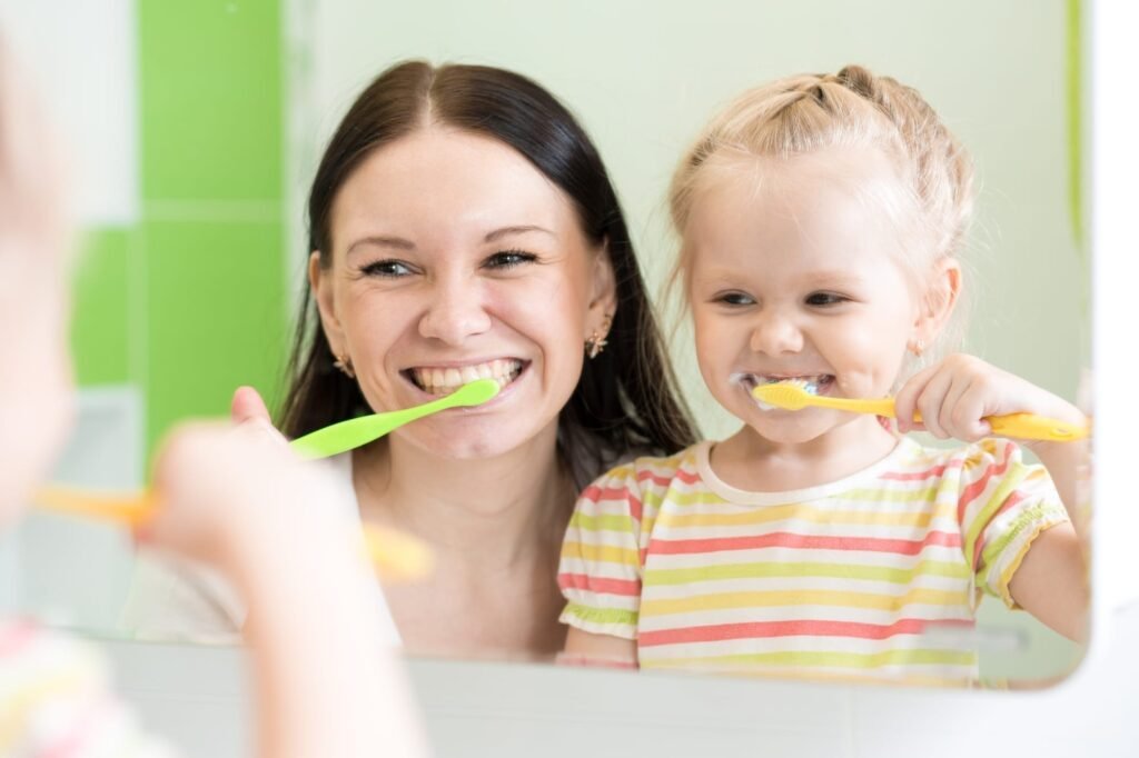 child teeth brushing parent